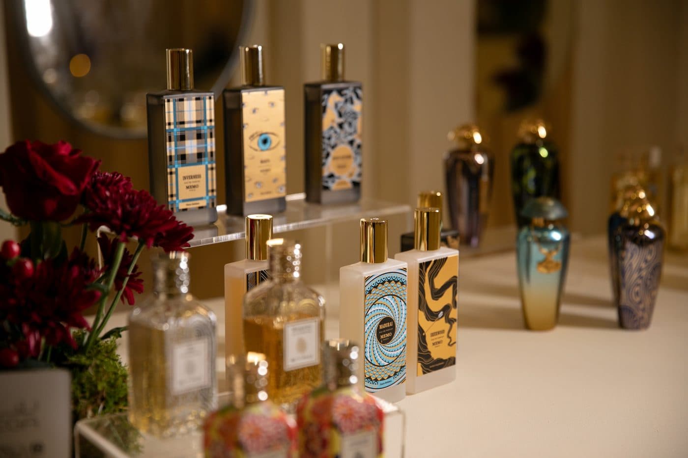 French perfumes and Arabic blends beside red roses