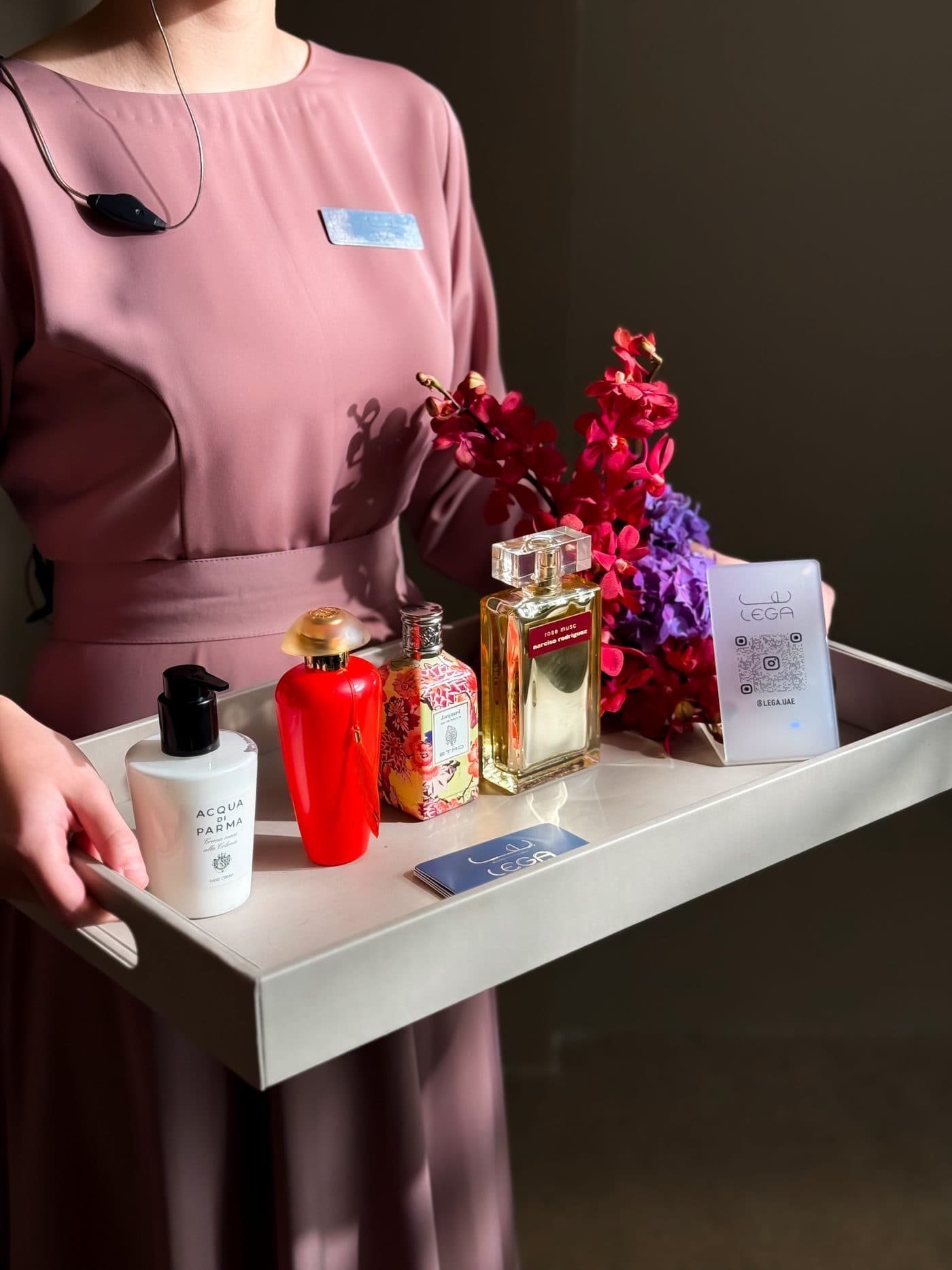 A Lega hostess presenting a tray of perfumes