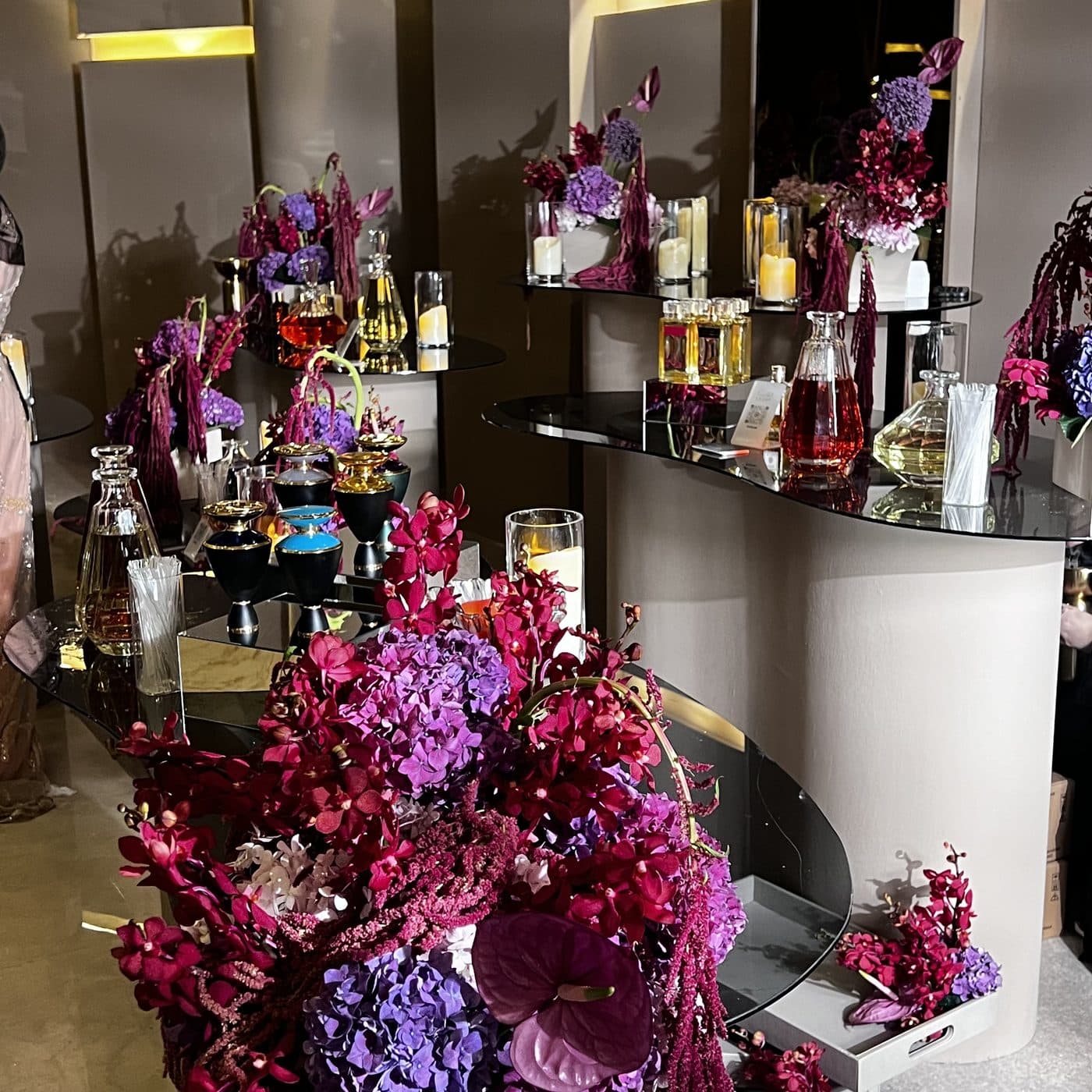 Mirrored perfume table with magenta florals