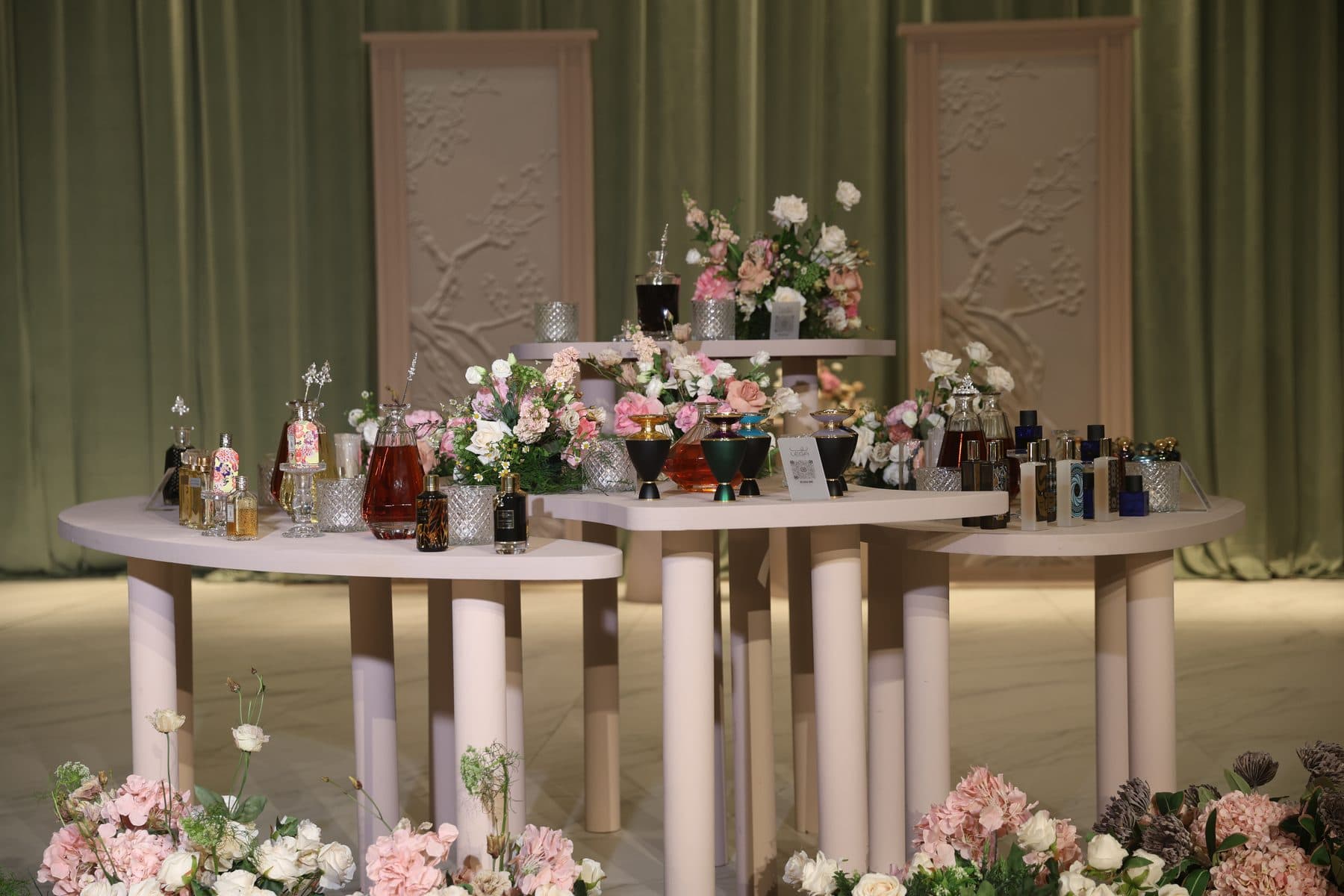 Perfume table styled with pink florals